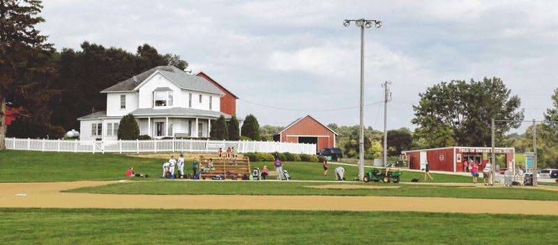 Ghost players grab balls from a bag at the original Lansing Farm site in  Dyersville, Iowa, where the nostalgic movie Field of Dreams was filmed in  1989