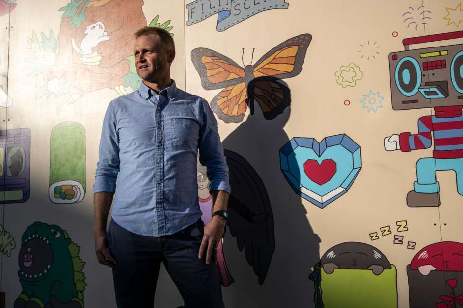 Entrepreneur Nate Kaeding, a former Hawkeyes and San Diego Chargers kicker, stands in the Raygun store in Iowa City on Wednesday. Kaeding returned to Iowa after his pro football career to start Gold Top Hospitality, which operates restaurants, and also teams with Build to Suit, a company behind dozens of apartment, health care, industrial and retail and restaurant projects. (Geoff Stellfox/The Gazette)