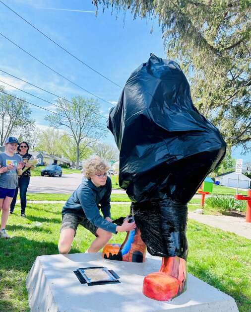 Archie Damschen, 13, of Iowa City, unveiled his Herky mascot design in front of a crowd of friends and family Wednesday morning across the street from Stella Restaurant in University Heights.  (Vanessa Miller/The Gazette) 
