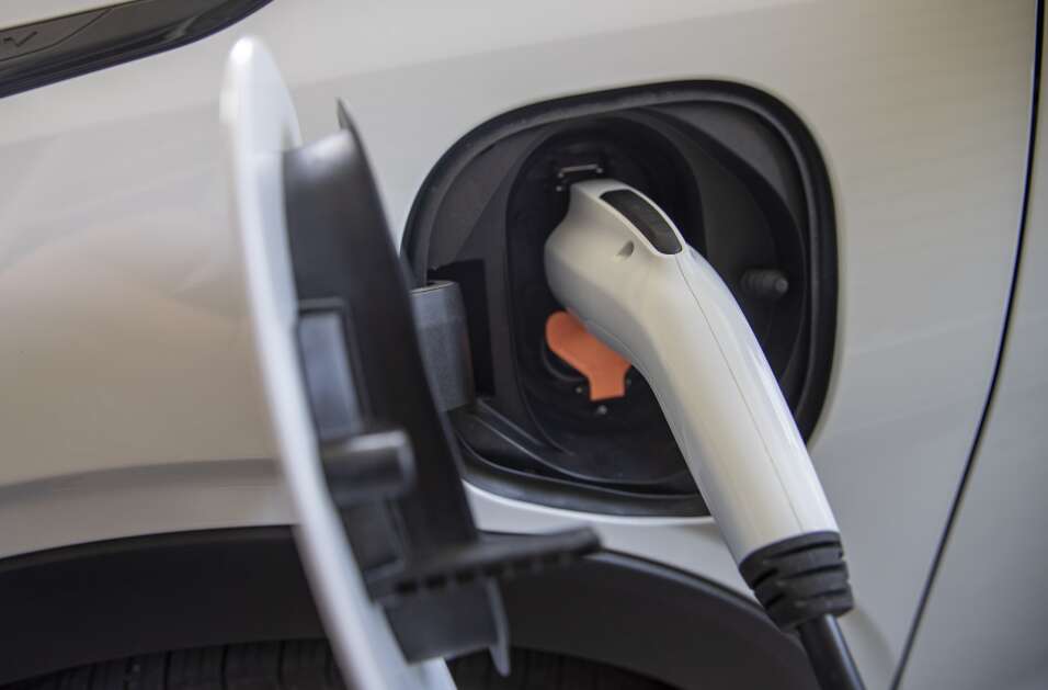A small electric vehicle charger plugs into Mike Carberry’s Chevy bolt at his home in Iowa City, Iowa on Tuesday, June 27, 2023. (Savannah Blake/The Gazette)


