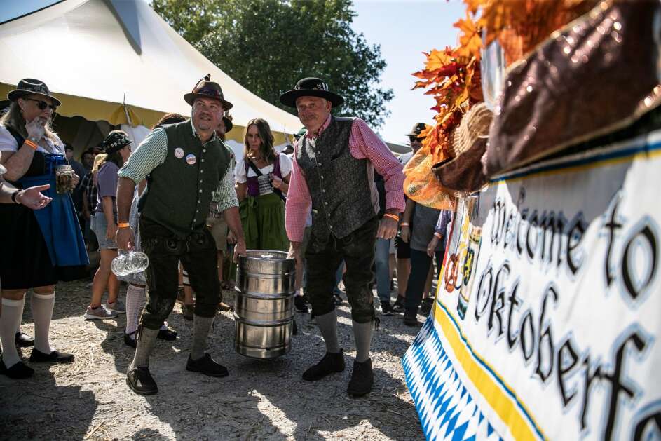 Amana Oktoberfest burgermeister Tom Kellenberger (right) leads the way for the keg tapping at the Amana Oktoberfest keg tapping party on Friday, Sept. 29, 2023, at the Amana Oktoberfest grounds in Amana, Iowa. The 2024 celebration will be held Oct. 4 to 6. (Geoff Stellfox/The Gazette)