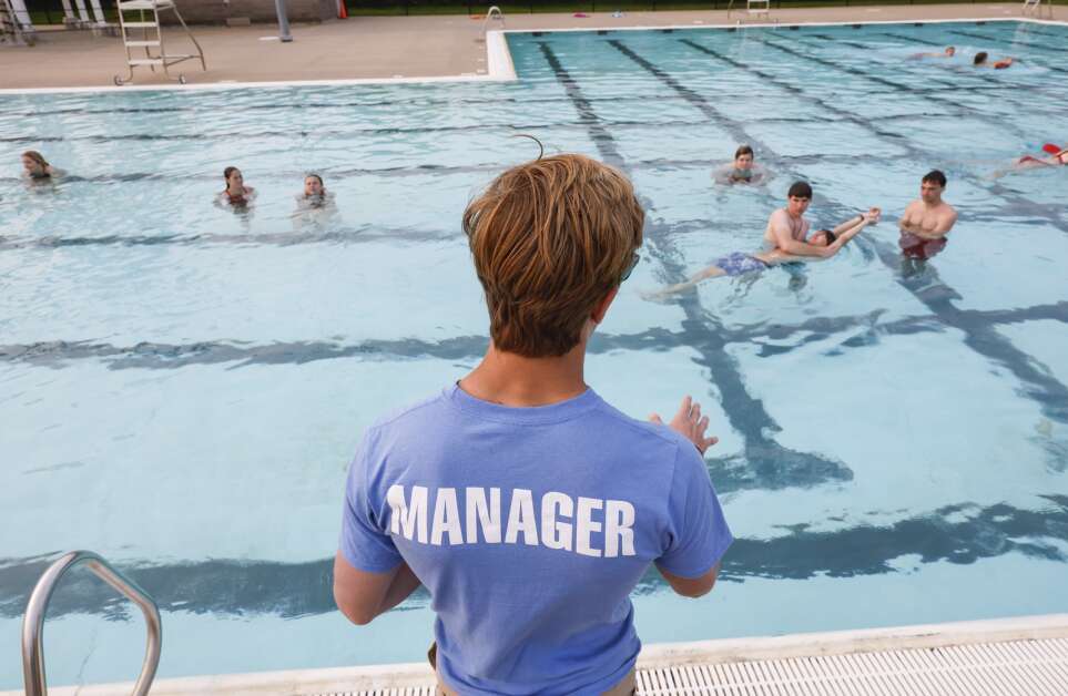 Manager Xander Scaglione directs lifeguard-in-training during training exercises at Cherry Hill Aquatic Center in northwest Cedar Rapids, Iowa, on Wednesday, May 17, 2023. Pools in the Corridor will open for the season this Memorial Day weekend.  (Jim Slosiarek/The Gazette)