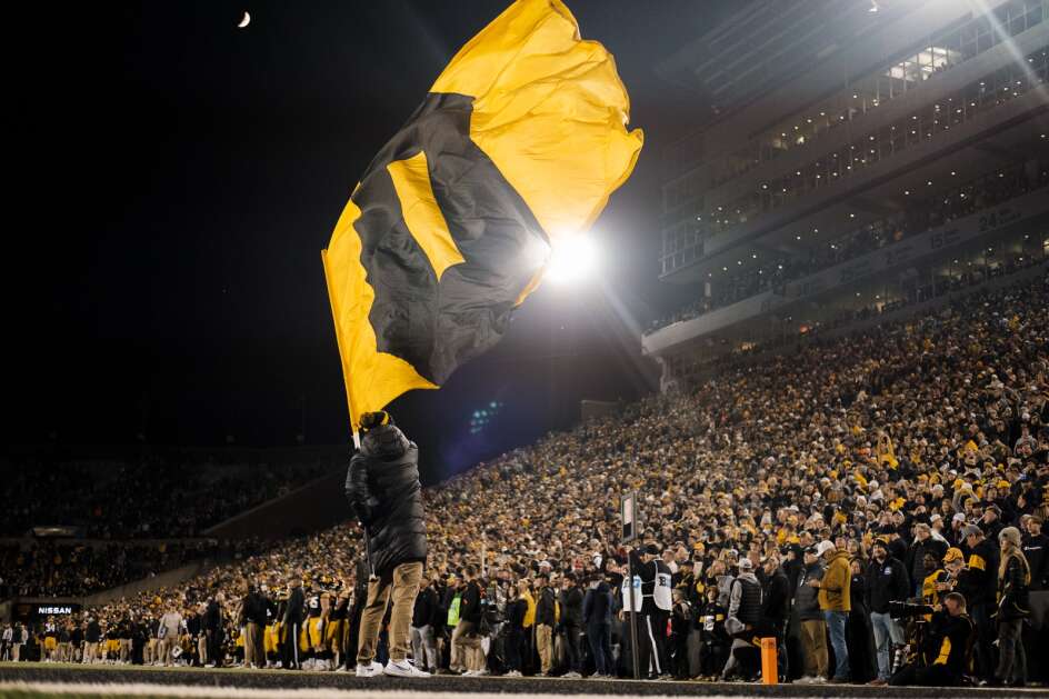 The “O” flag is waved during a game between the Iowa Hawkeyes and the Illinois Fighting Illini at Kinnick Stadium in Iowa City, Iowa on Saturday, Nov. 18, 2023. The Hawkeyes defeated the Illini 15-13 and with the win clinched the Big Ten West title. (Nick Rohlman/The Gazette)