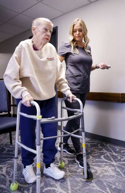 Doctor of Physical Therapy and Director of Rehab Services Amanda Rose walks with resident Margaret Selzer as they demonstrate a gait analysis exercise at West Ridge Care Center in northwest Cedar Rapids on May 8. (Jim Slosiarek/The Gazette)