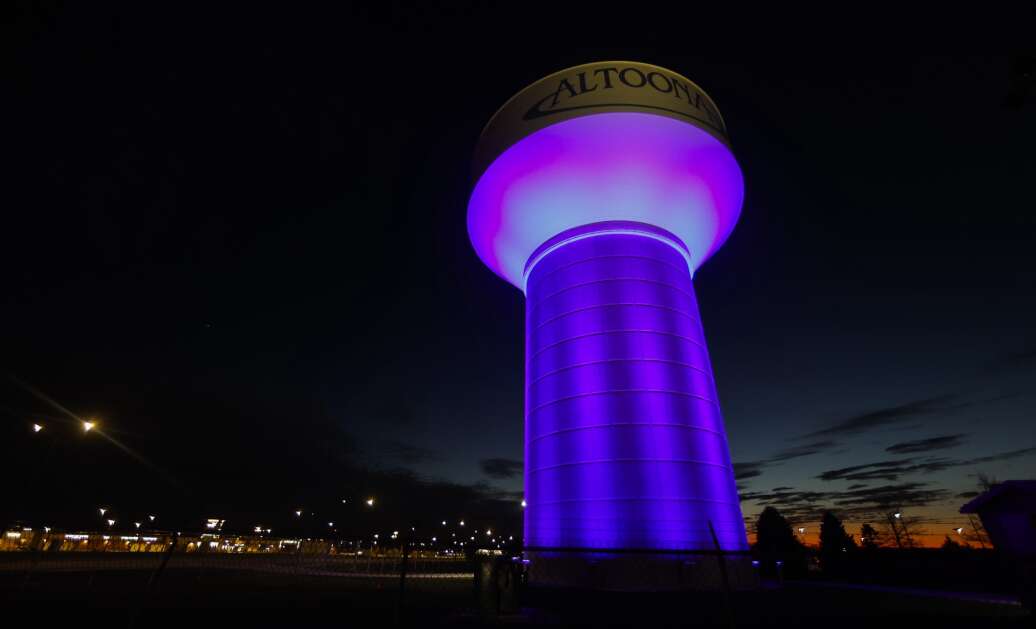A water tower is lit in the evening hours April 19 in Altoona. The water tower is located close to the Adventureland amusement park and the Prairie Meadows Casino & Racetrack on the south side of Interstate 80. (Jim Slosiarek/The Gazette)