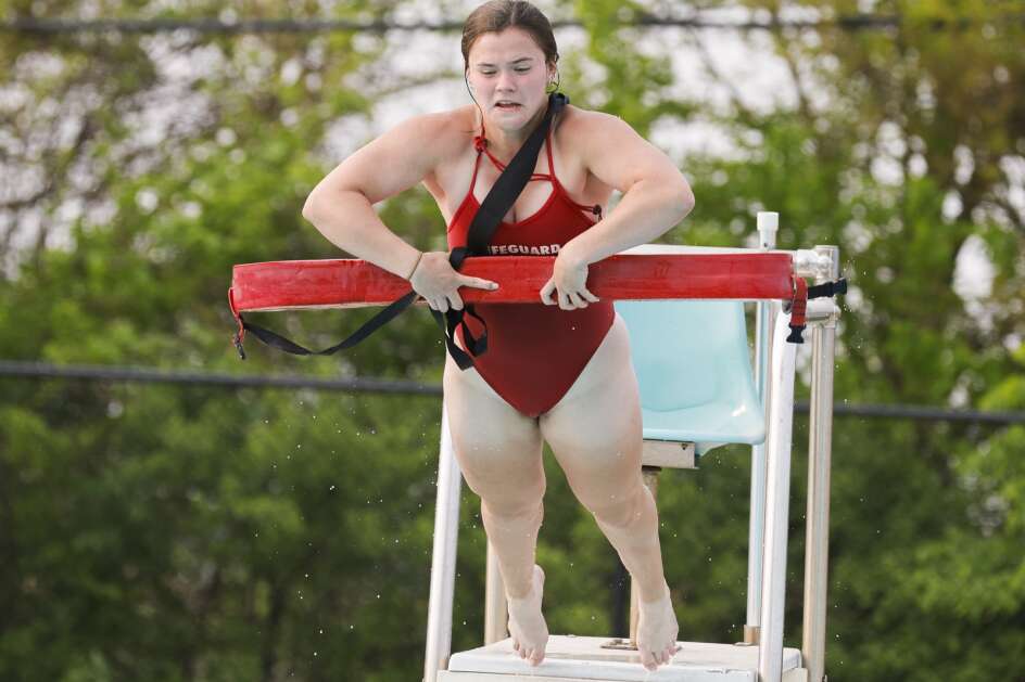 Ellie Hance, 17, leaps off the lifeguard platform as she practices water rescues during lifeguard training at Cherry Hill Aquatic Center in northwest Cedar Rapids, Iowa, on Wednesday, May 17, 2023. Pools in the Corridor will open for the season this Memorial Day weekend.  (Jim Slosiarek/The Gazette)