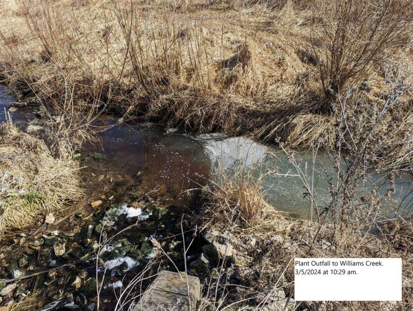 Red-tinted wastewater is seen March 5 in Williams Creek near Postville. A blocked sewer line at Agri Star caused a pump station to flood, sending untreated water from the beef kill facility to the Postville city water treatment plant, the city reported to the Iowa Department of Natural Resources. (City of Postville)