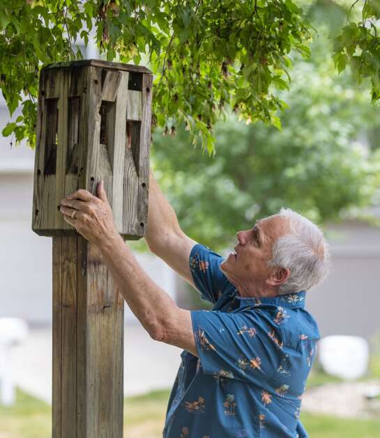 Dave Langston puts the cover back on a light post while doing work around their home in southeast Cedar Rapids on June 20. Dave is the president of the Beaver Creek Homeowners Association and looked for a new homeowners policy for four months after being dropped by his previous insurance. The couple was insured by Pekin Insurance and were informed the company would be stopping their coverage due to no longer covering the state of Iowa. (Savannah Blake/The Gazette)