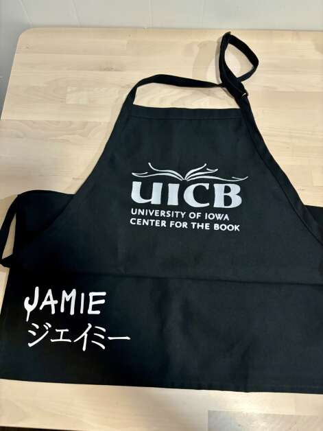 Jamie Capps’ instructors at the University of Iowa Center for the Book made an apron for her to mark her completion of a master’s degree in book arts. Her name also is printed in Japanese, signifying the study she did with Asian generational papermakers.  (Justin Torner/Contributed)