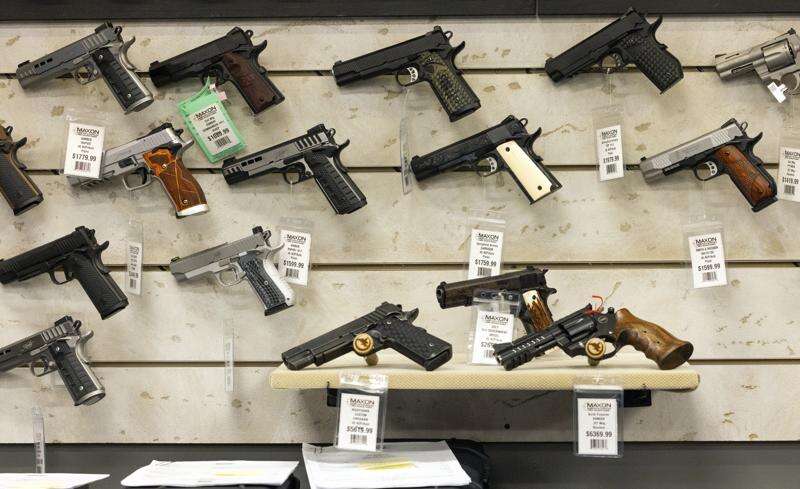 Guns for sale are displayed at Maxon Shooter's Supplies in Des Plaines, Ill., June 25. A new national divide is emerging among states over whether to track sales by gun stores. A California law taking effect Monday will require credit card networks to provide banks with special retail codes to assign to gun stores. By contrast, new laws taking effect in Georgia, Iowa, Tennessee and Wyoming will prohibit the use of special gun shop codes in financial transactions. A total of 17 states have passed some sort of limit on category codes for gun retailers, while California has been joined by Colorado and New York. (AP Photo/Teresa Crawford)