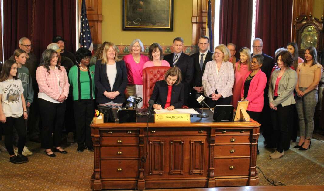 Iowa Gov. Kim Reynolds on Wednesday signs into law legislation that will require insurance companies to cover diagnostic breast exams during a ceremony in the Iowa Capitol in Des Moines. (Erin Murphy/The Gazette)