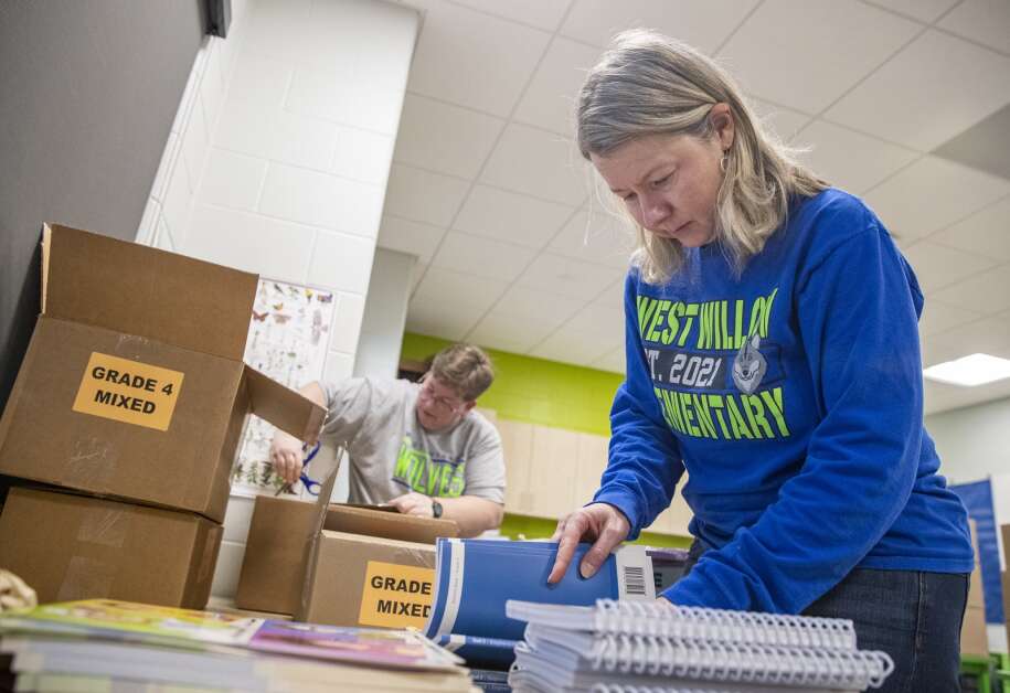 Teacher-librarian Kathy Goedeken checks fourth-grade curriculum books April 19 at West Willow Elementary School in Cedar Rapids. A new curriculum for elementary school students in the Cedar Rapids Community School District based on the evidence-based literacy technique called “science of reading” will be launched this fall. (Savannah Blake/The Gazette)