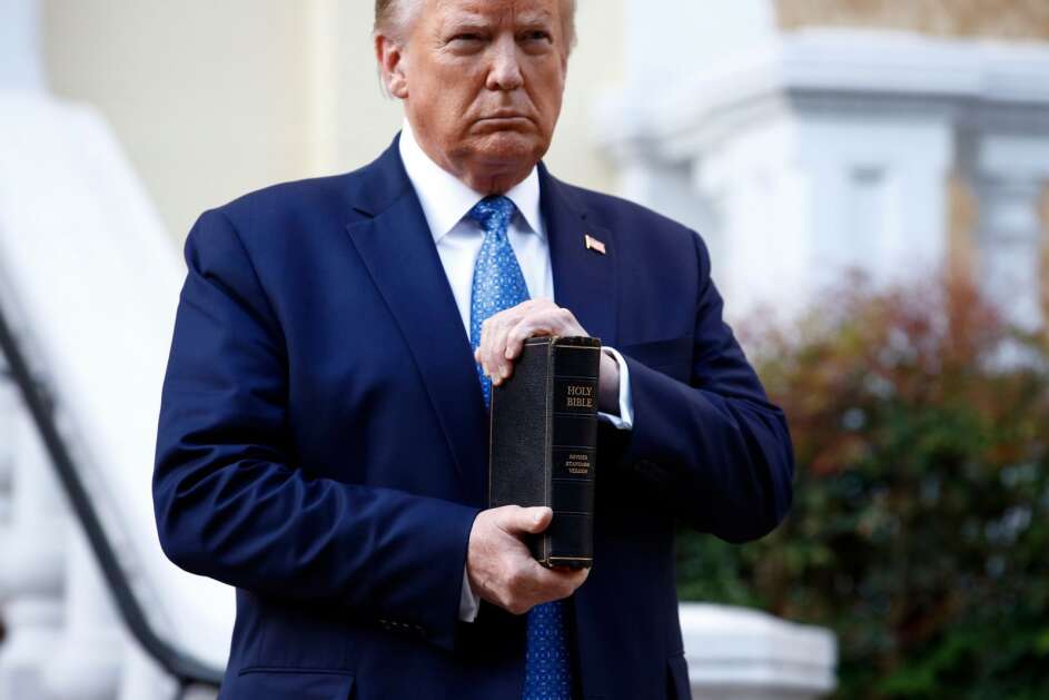 President Donald Trump holds a Bible as he stands outside St. John's Church across Lafayette Park from the White House in Washington on June 1, 2020, after law enforcement officers used tear gas and other riot control tactics to forcefully clear peaceful protesters from the area. (AP Photo/Patrick Semansky)