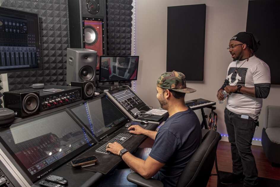 Richard Shultz (left) and Antonio “Tone da Boss” Chalmers (right) work at The Sound Box Recording Studio in Cedar Rapids, Iowa on Tuesday, December 13, 2022. Chalmers was working on the mix and recording of his single “Stick Up” with CHISongwriter. (Nick Rohlman/The Gazette)
