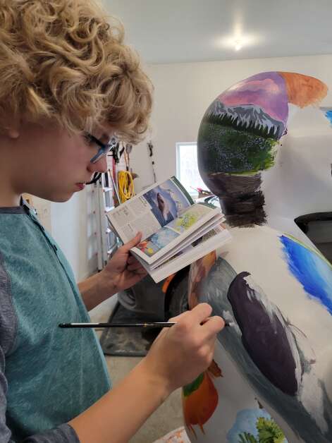 Archie Damschen, 13, of Iowa City, is the youngest artist ever chosen to design and create the Herkie mascot for Think Iowa City's Herkie on Parade. Archie's Herkey, released Wednesday morning, is covered in depictions of national parks and has been dubbed 