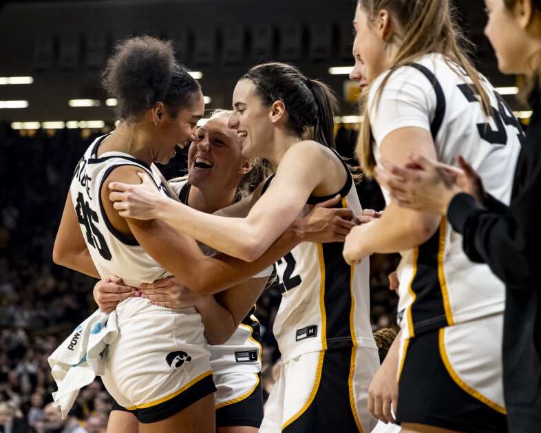 Iowa forward Hannah Stuelke (45) celebrates with Sydney Affolter (3) and Caitlin Clark (22) after coming out of the game Thursday at Carver-Hawkeye Arena. Stuelke scored a career-high 47 points in Iowa’s 111-93 win. It also was a Carver-Hawkeye record, women’s or men’s basketball. (Nick Rohlman/The Gazette)