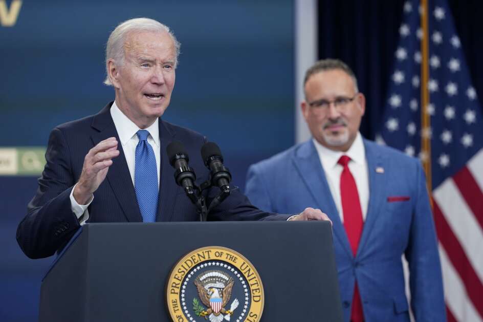 President Joe Biden speaks about the student debt relief portal beta test as Education Secretary Miguel Cardona listens in the South Court Auditorium on the White House complex in Washington, Monday, Oct. 17, 2022. (AP Photo/Susan Walsh)