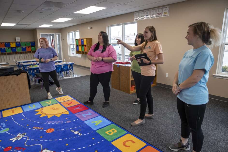 Fields of Fun owner Taryn Krahmer (second from right) talks with staff March 29, 2022, at Fields of Fun Child Care in Cedar Rapids. Fields of Fun is opening at the former location of Kids Inc. and received a state child care center grant. (Nick Rohlman/The Gazette)