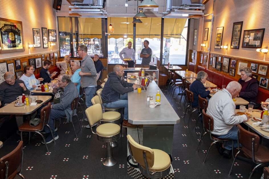 People sit in the reopened Hamburg Inn No. 2 in Iowa City on Oct. 11 after Nate Kaeding’s company, Gold Cap Hospitality, reopened the famed restaurant. (Nick Rohlman/The Gazette)