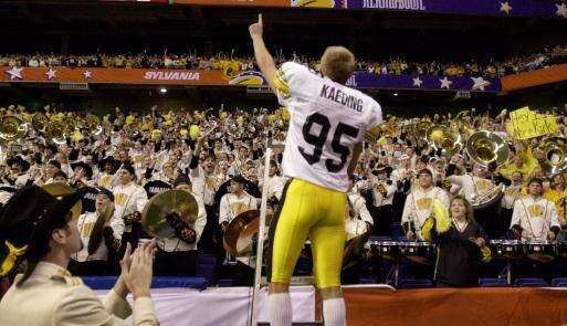 Iowa Hawkeyes kicker Nate Kaeding celebrates with Iowa fans and the University of Iowa band after Iowa defeated Texas Tech in the Dec. 29, 2001, Alamo Bowl in San Antonio, Texas. Kaeding kicked four field goals in Iowa’s 19-16 win. The 41-year-old Kaeding is now an entrepreneur in the Corridor. (Associated Press) 