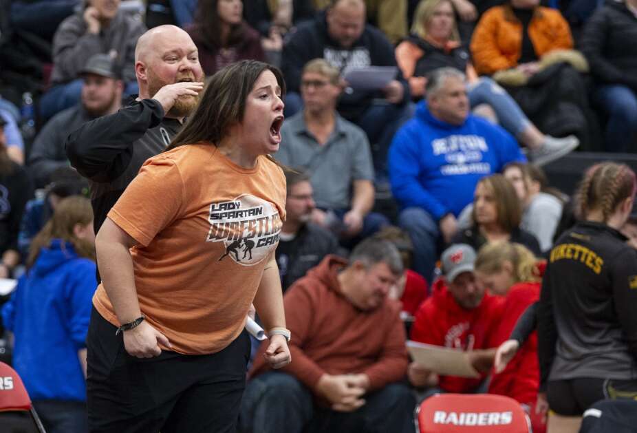 Solon Assistant Coach Kaitlin Hatcher and Head Coach Jake Munson yell out to Alexis Anderson on Jan. 23, 2023, as she wrestles in a 140 pound match during the WaMaC girls wrestling tournament at Williamsburg High School in Williamsburg. (Savannah Blake/The Gazette)
