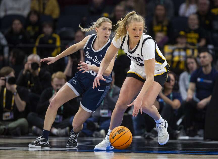 Iowa's Sydney Affolter (3) dribbles the ball against pressure from Penn State's Makenna Marisa in the quarterfinals of the Big Ten women's basketball tournament Friday night at the Target Center in Minneapolis.  Iowa faces Michigan in the semifinals at 3:30 p.m. Saturday.  (Savannah Blake/The Gazette)
