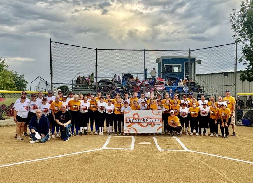 Players and coaches from Benton Community and North Linn pose for a photo during Cancer Awareness Night at Van Horne.  (Photo by Andrea Townsley)
