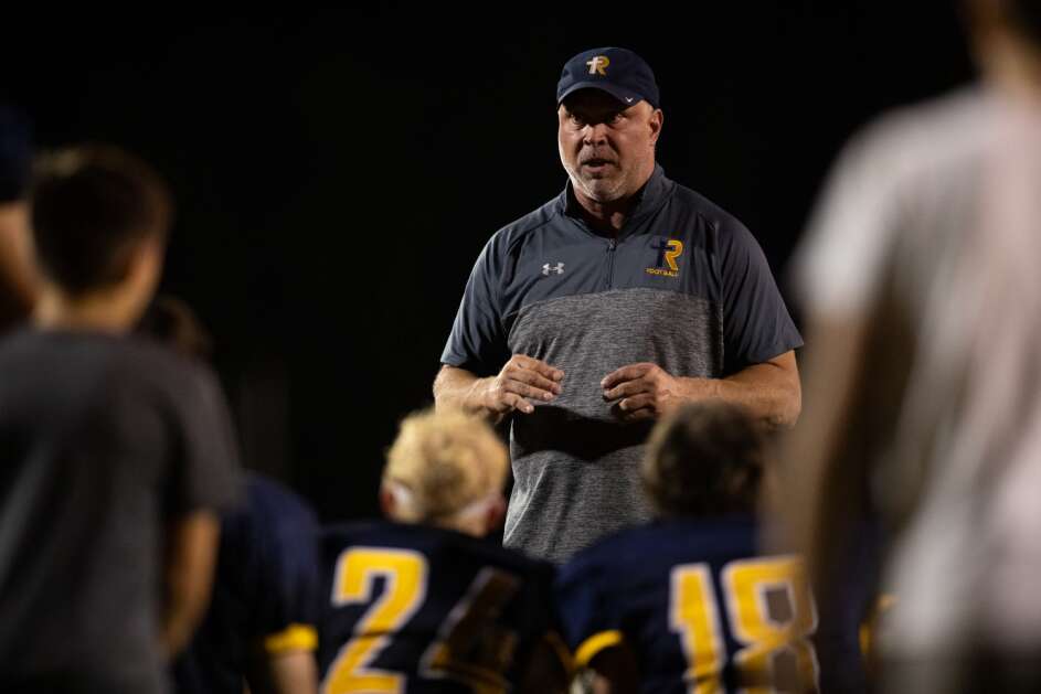 Players listen to Regina head coach Jason Dumont after a high school football game between the Regina Regals and Mid-Prairie Hawks At Regina High School in Iowa City, Iowa on Friday, Sept. 1, 2023. The Regals defeated the Hawks 51-19. (Emily Nyberg/The Daily Iowan)