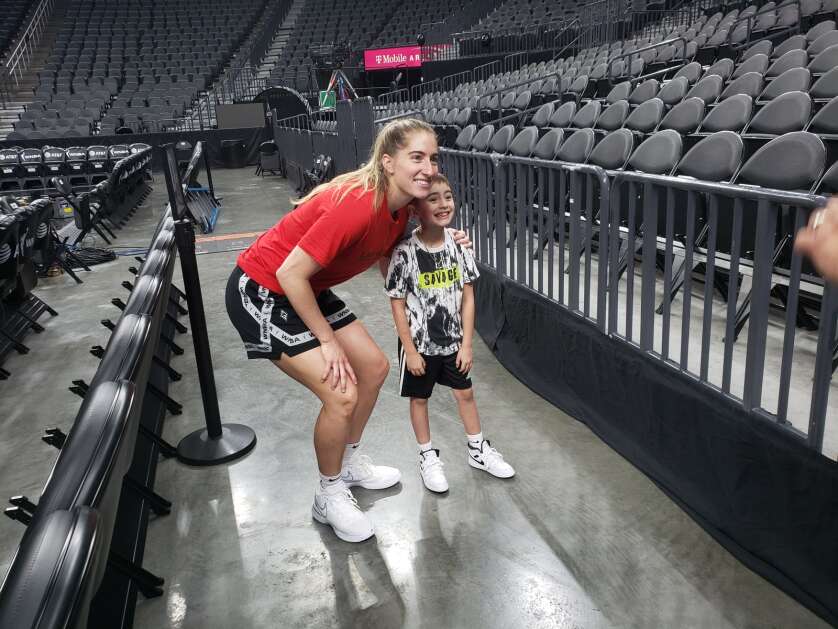 Kate Martin of the Las Vegas Aces poses with 8-year-old Aces fan Vance Jackson of San Antonio, Texas, after the Aces' Tuesday morning shootaround at T-Mobile Arena in Las Vegas. (Mike Hlas/The Gazette)