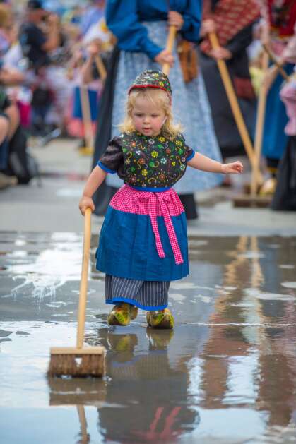Even the tiniest Pella residents get in on the street scrubbing fun during Tulip Time. The 2024 celebration will be held May 2 to 4. (Courtesy of Visit Pella)