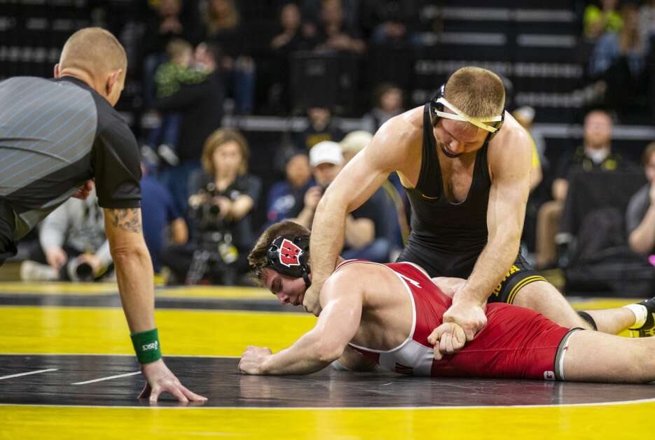 Iowa’s Patrick Kennedy wrestles Wisconsin’s Cale Anderson at 174 pounds during a meet between the Hawkeyes and the Badgers at Carver-Hawkeye Arena in Iowa City, Iowa on Sunday, Feb. 18, 2024. Kennedy won against Anderson 19-4. (Savannah Blake/The Gazette)