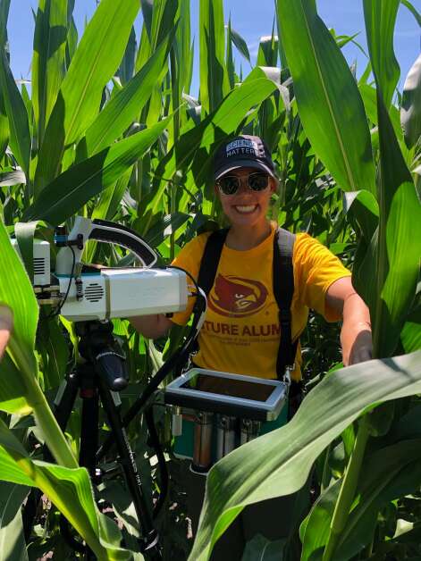 Madelynn Wuestenberg takes photosynthesis measurements while working as an undergraduate research assistant at Iowa State University. Wuestenberg now is the agricultural climatologist for ISU Extension & Outreach. (Photo courtesy of Madelynn Wuestenberg)