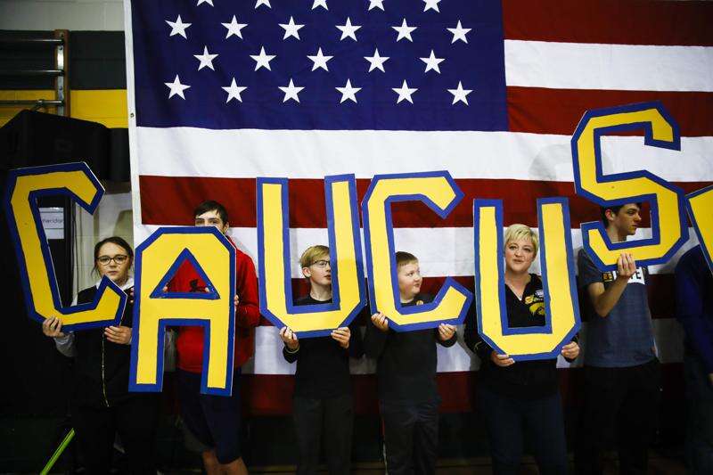 FILE - In this Sunday, Feb. 2, 2020, file photo, attendees hold letters that read 'CAUCUS' during a campaign event for Democratic presidential candidate former South Bend, Ind., Mayor Pete Buttigieg at Northwest Junior High, in Coralville. (AP Photo/Matt Rourke, File)
