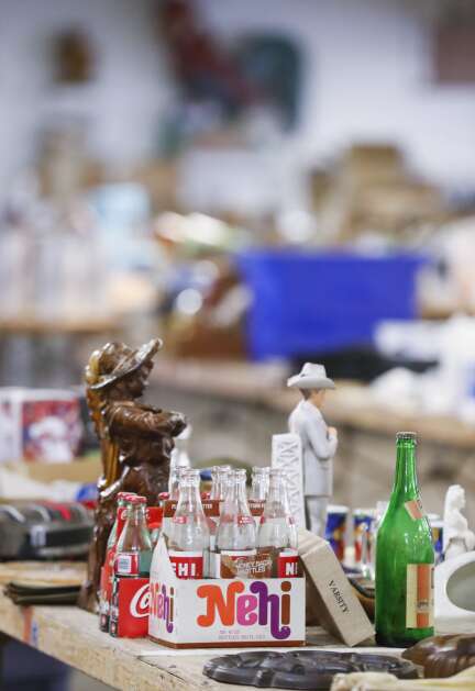 Collectible bottles and figurines are among the items awaiting auction at Sharpless Auctions east of Iowa City.  (Jim Slosiarek/The Gazette)