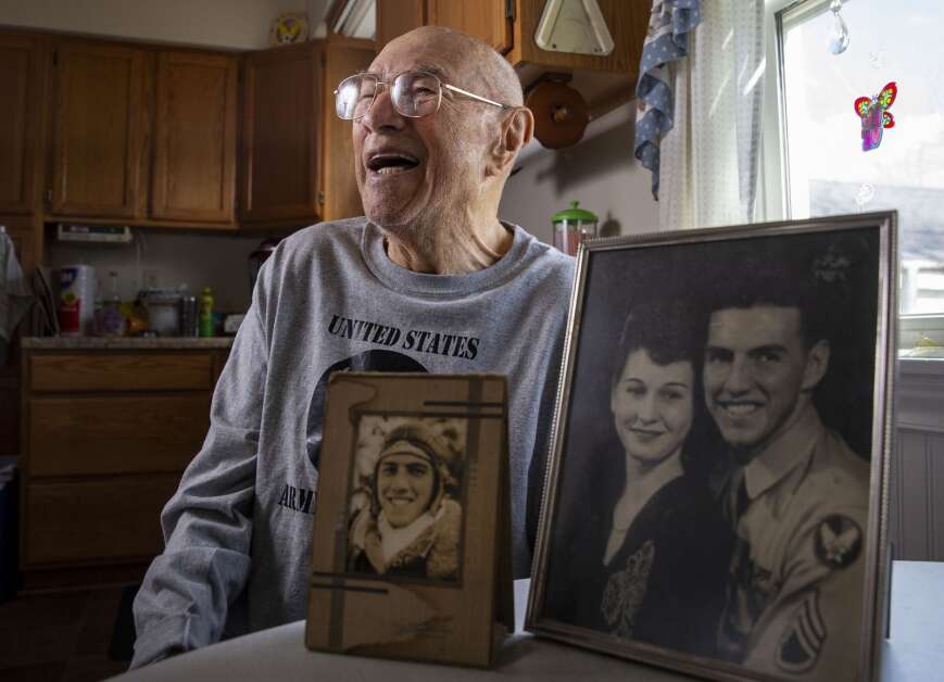 World War II veteran Mike Bisek talks about his time in the service in his home in Cedar Rapids on April 10. Bisek worked as an aerial photographer with a bomber crew and was headed toward Switzerland when he and the rest of the crew had to bail out of the plane into occupied France. (Savannah Blake/The Gazette)