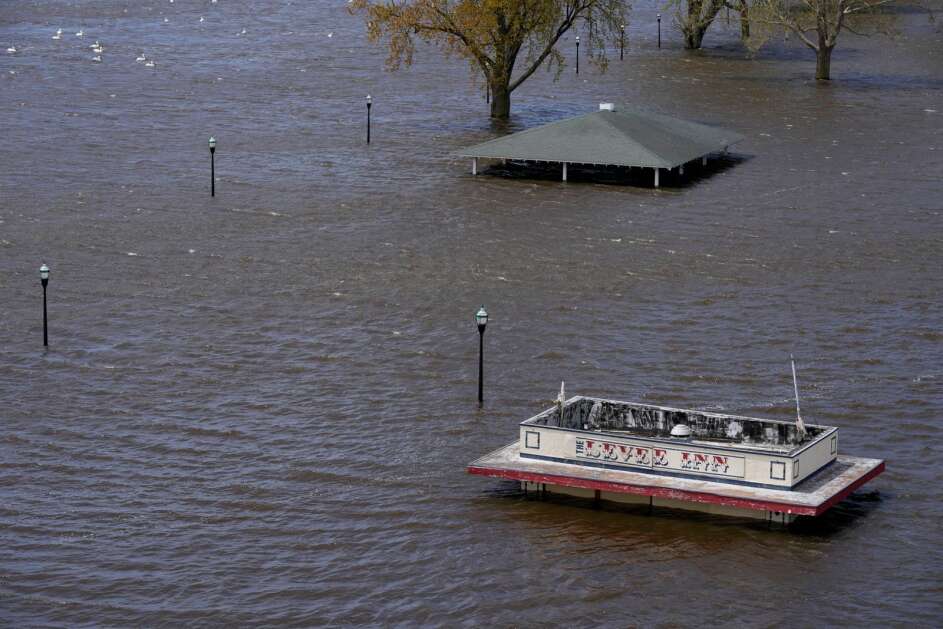 A snack shop sits in floodwaters Monday from the nearby Mississippi River in downtown Davenport. The rising Mississippi River is testing flood defenses in Southeast Iowa and Northwest Illinois as it crests in the area, driven by a spring surge of water from melting snow. (AP Photo/Charlie Neibergall)