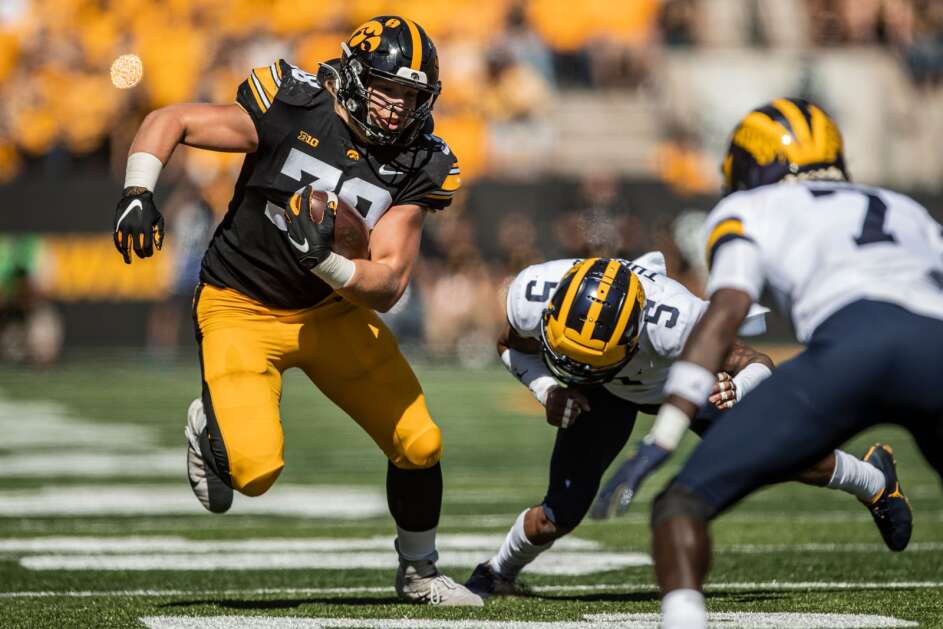 Iowa Hawkeyes fullback Monte Pottebaum (38) runs with the ball during a game between the Iowa Hawkeyes and the Michigan Wolverines at Kinnick Stadium in Iowa City, Iowa on Saturday, October 1, 2022. The Wolverines defeated the Hawkeyes 27-14. (Nick Rohlman/The Gazette)