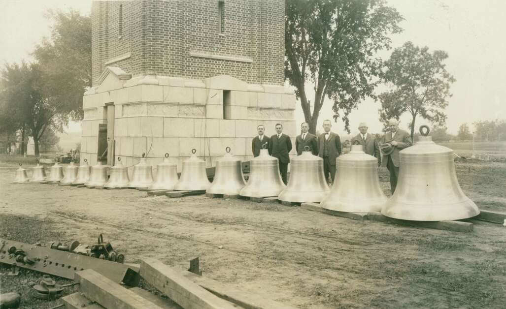 School representatives pose for a photo alongside the original 15-bell chime set before it was first installed in the campanile of what was then called the Iowa State Teachers College in 1926. College President Homer Seerley stands on the right. In May 2023, the University of Northern Iowa started installing new bells, bringing the total to 56. (University of Northern Iowa)