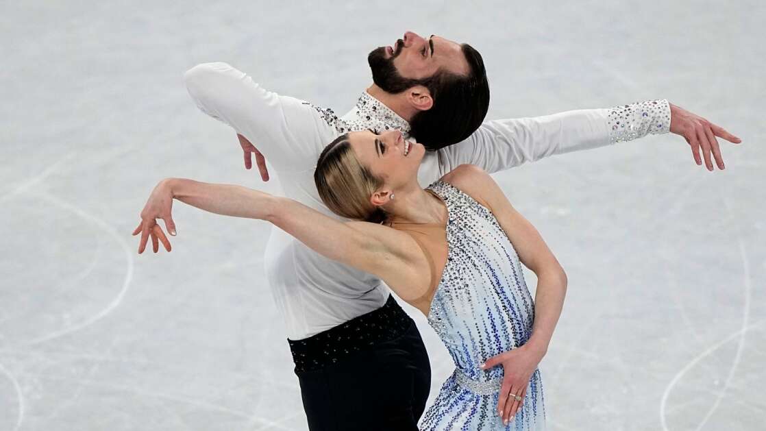 Ashley Cain-Gribble and Timothy LeDuc, of the United States, compete in the pairs short program during the figure skating competition at the 2022 Winter Olympics in Beijing. The duo placed eighth, and realized a lifelong dream for LeDuc, a Cedar Rapids native. Now retired from competition, LeDuc is a coach, based in Chicago, and is returning for the Eastern Iowa Figure Skating Club's two "Broadway on Ice" shows May 20, 2023, at the ImOn Ice Arena in southwest Cedar Rapids. (AP Photo/David J. Phillip)