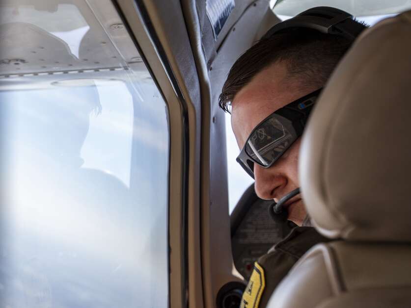 Iowa State Patrol Trooper Taylor Grim watches for fast-moving vehicles Friday along Highway 218 while on patrol in one of the seven small planes operated by the state patrol. Grim said watching vehicles from the air makes it easier to spot drivers who are speeding or driving recklessly. (Savannah Blake/The Gazette)