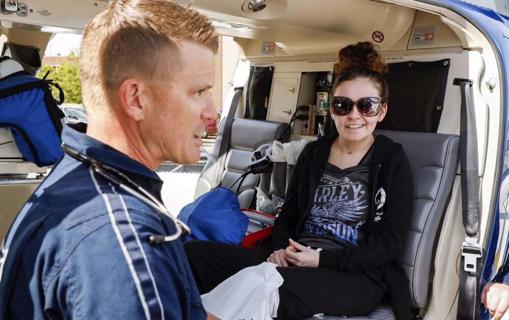Isabella Sellers smiles Wednesday as she listens to flight nurse Nate Johnson as she tours a LifeGuard Air Ambulance helicopter at UnityPoint Health-St. Luke’s Hospital in northeast Cedar Rapids. (Jim Slosiarek/The Gazette)