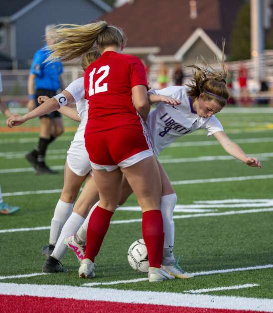 Marion defender Sydney Fox (12) blocks Iowa City Liberty midfielder Callie Stanley (8) as they compete for possession of the ball in the second half of the game at Marion High School in Marion, Iowa on Thursday, May 25, 2023. (Savannah Blake/The Gazette)