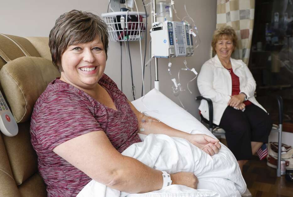 Michelle Stevens of Kearney, Neb., sits with her mother Connie Stevens for a cancer treatment at the Hall-Perrine Cancer Center at Mercy Medical Center in southeast Cedar Rapids, Iowa, Monday, September 11, 2023. Stevens travels to Cedar Rapids every six months for her cancer chemotherapy treatments. Stevens has had four rounds of chemo and 20 rounds of radiation. Stevens says the center does a good job at scheduling tests and other appointments for the same day to make her long trip more efficient. (Jim Slosiarek/The Gazette)
