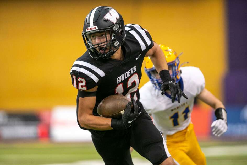 Williamsburg’s Derek Weisskopf (12) looks downfield for extra yardage during a Class 2A Iowa high school state football semifinal game on Saturday, Nov. 12, 2022, at the UNI-Dome in Cedar Falls, Iowa. The Raiders defeated the Golden Eagles 31-7. (Geoff Stellfox/The Gazette)