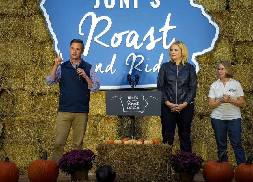 U.S. Congressional  candidate Zach Nunn, left, joins the stage with U.S. Rep.  Ashley Hinson, center, and Mariannette Miller-Meeks during U.S. Senator Joni Ernst's annual Roast and Ride on Saturday, Oct. 22, 2022, in Des Moines, Iowa. (Bryon Houlgrave/The Des Moines Register via AP)