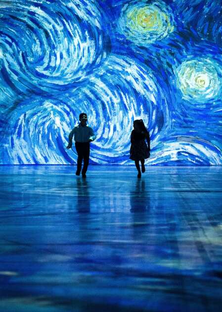 Children twirl and dance through this projection of "The Starry Night," part of "Beyond Van Gogh: The Immersive Experience," on display through July 20, 2023, in Davenport's RiverCenter. (Paquin Entertainment Group)