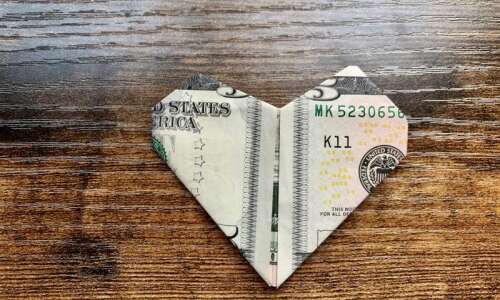 Make an origami heart with a dollar bill