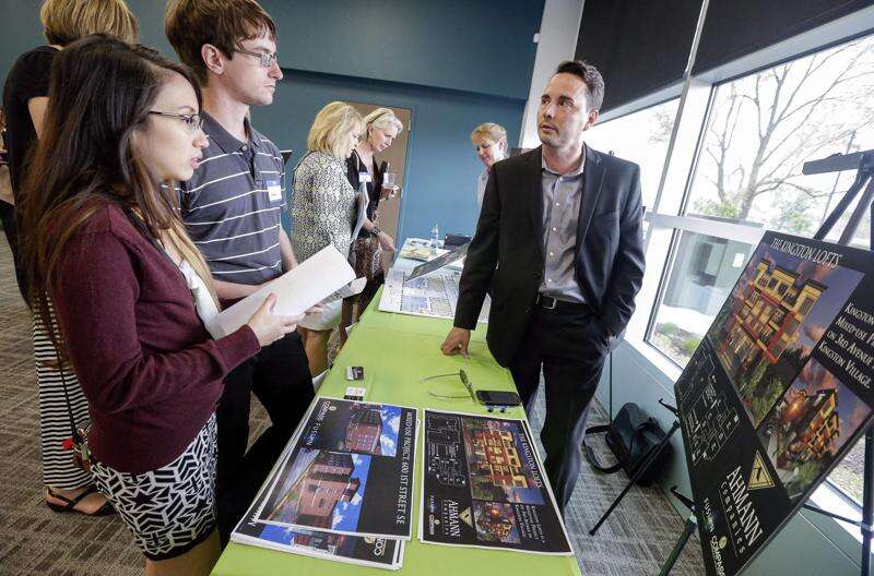 Developer Chad Pelley (right) talks to Alex Rannow (center) and Monique Rosete about the Kingston Lofts and a multiuse project in the former Great Furniture Mart building during an Urban Living in Downtown Cedar Rapids open house in 2021 at the Cedar Rapids Metro Economic Alliance. Jim Slosiarek/The Gazette