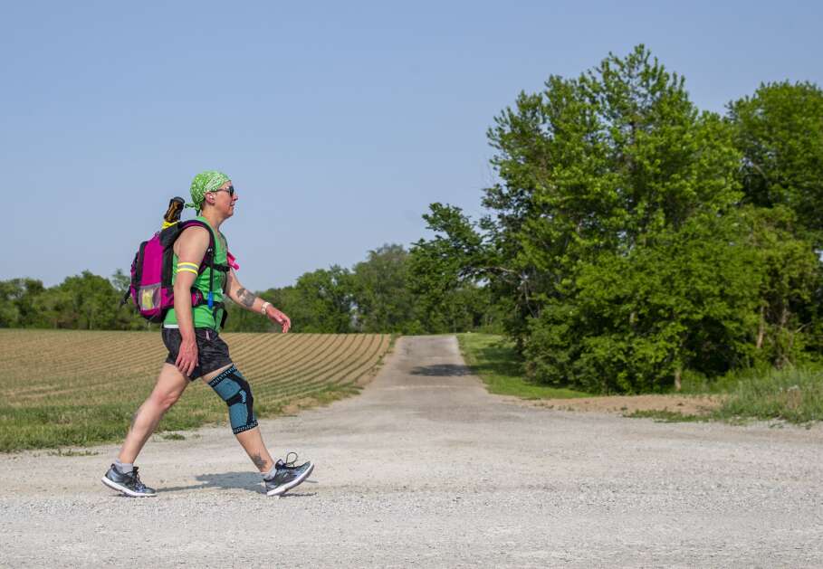 Karen Smith of Solon walks along a gravel road Tuesday in Shueyville while training for her walk across Iowa in June. Smith is raising money through for her walk and will donate the funds to four mental health organizations. (Savannah Blake/The Gazette)