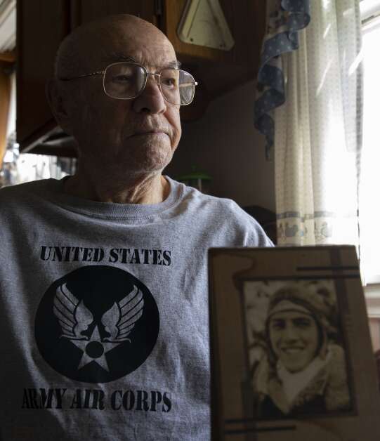 World War II veteran Mike Bisek poses for a portrait at his home in Cedar Rapids, Iowa on Monday, April 10, 2023. Mike turned 100 years old in 2023 and served as a bomber crew member who bailed out over occupied France during the war. Bisek was hidden and aided by the French resistance for six weeks until he was able to get to safety. (Savannah Blake/The Gazette)